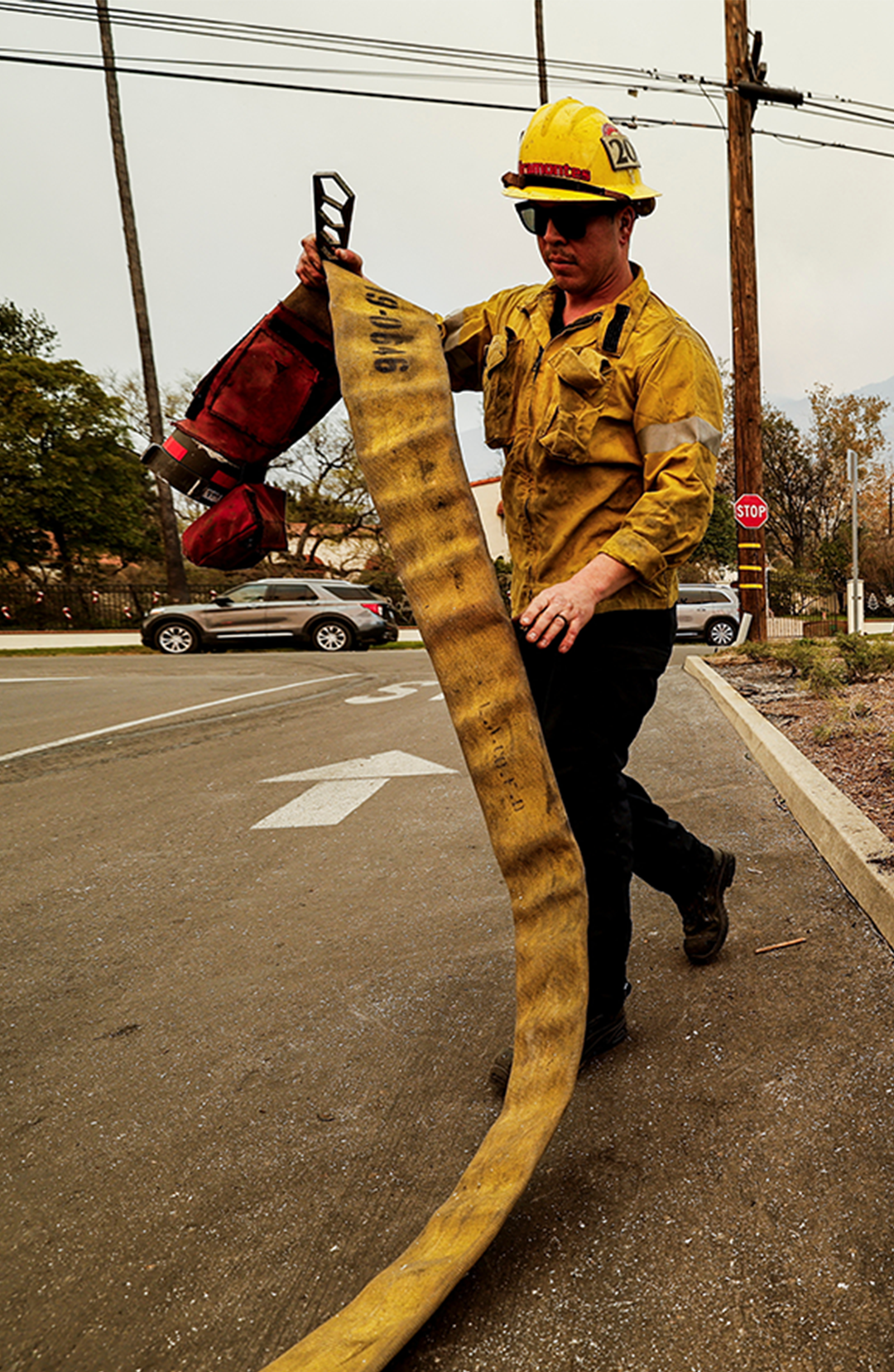 A firefighter walks away from an empty hydrant while fighting the Eaton Fire