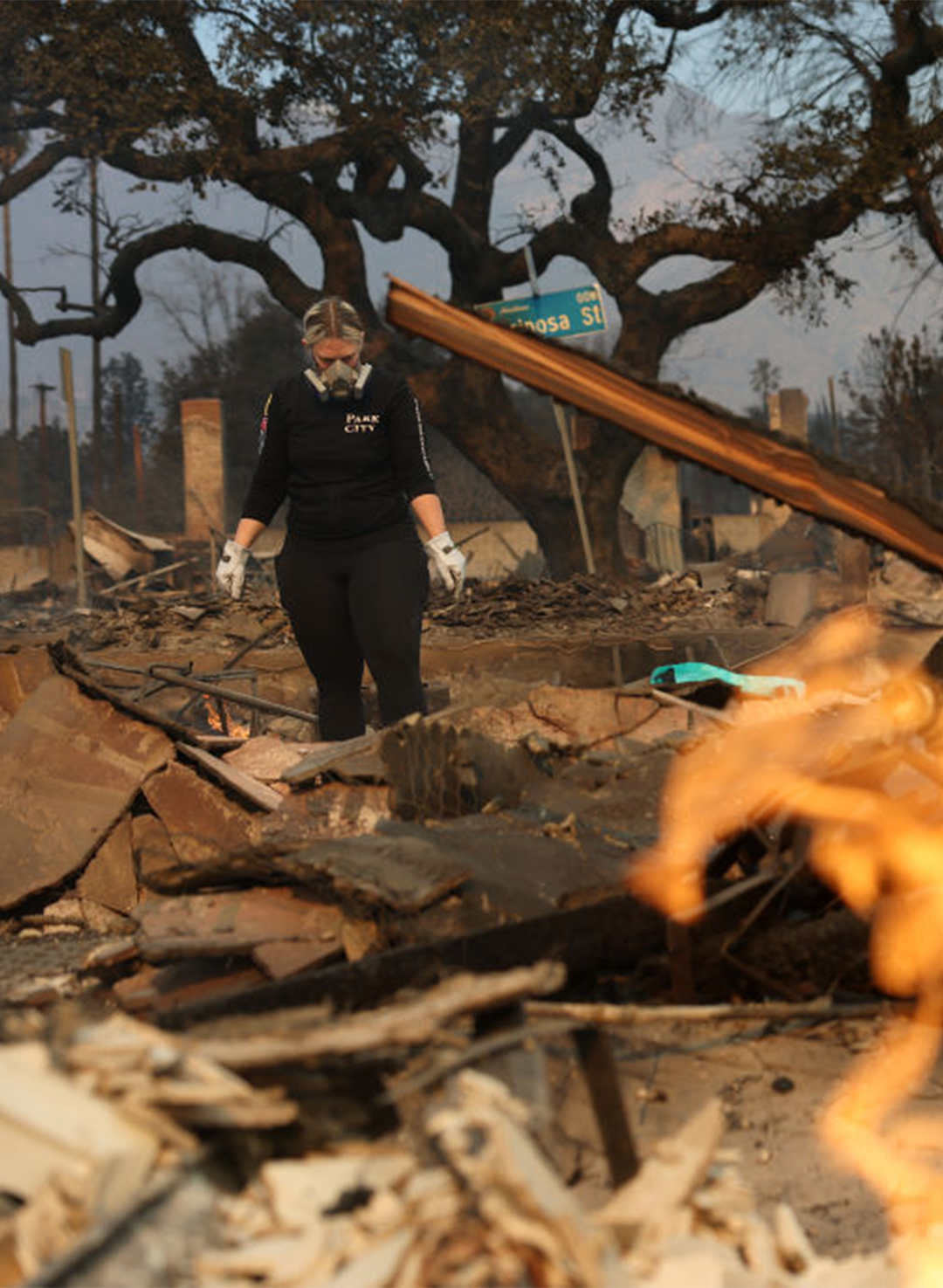 A resident inspects the remains of her home that was destroyed by the Eaton Fire on January 09, 2025 in Altadena, California