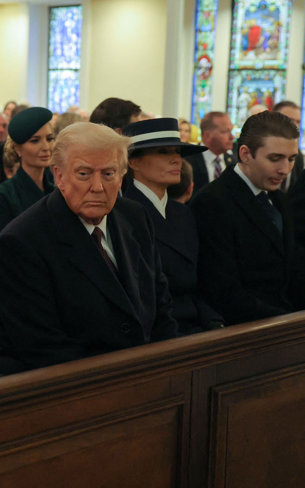 Donald Trump sits next to his wife Melania during a church service at St John's Episcopal Church