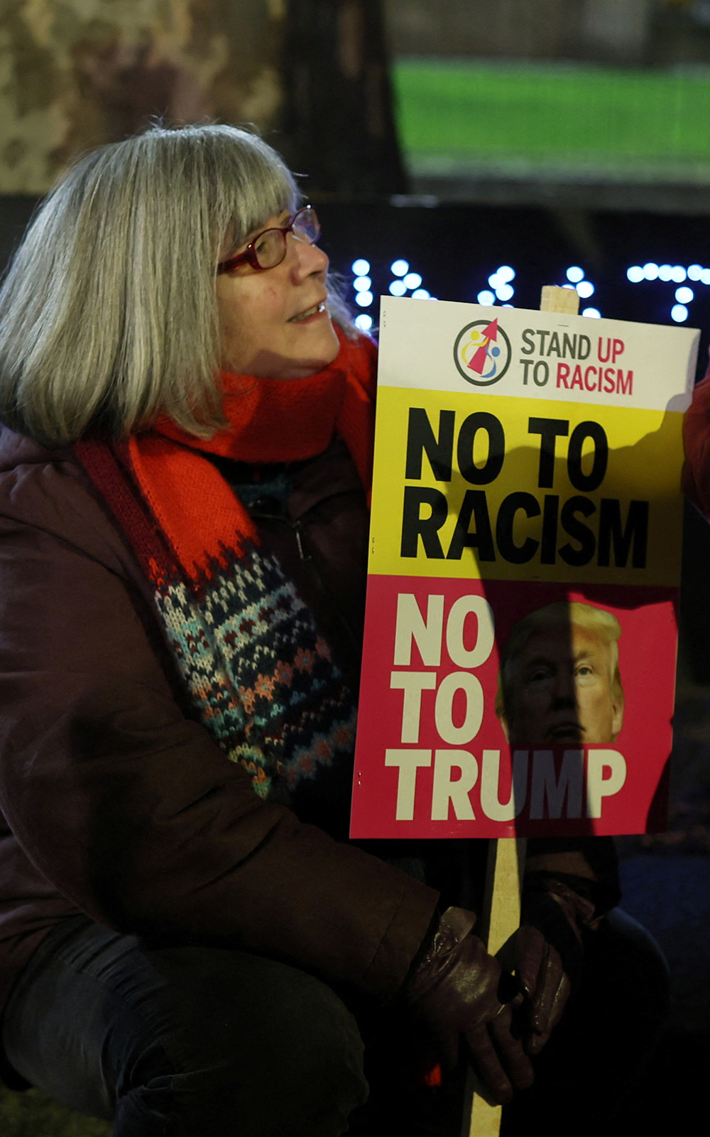 Demonstrators holding placards in London march against Trump