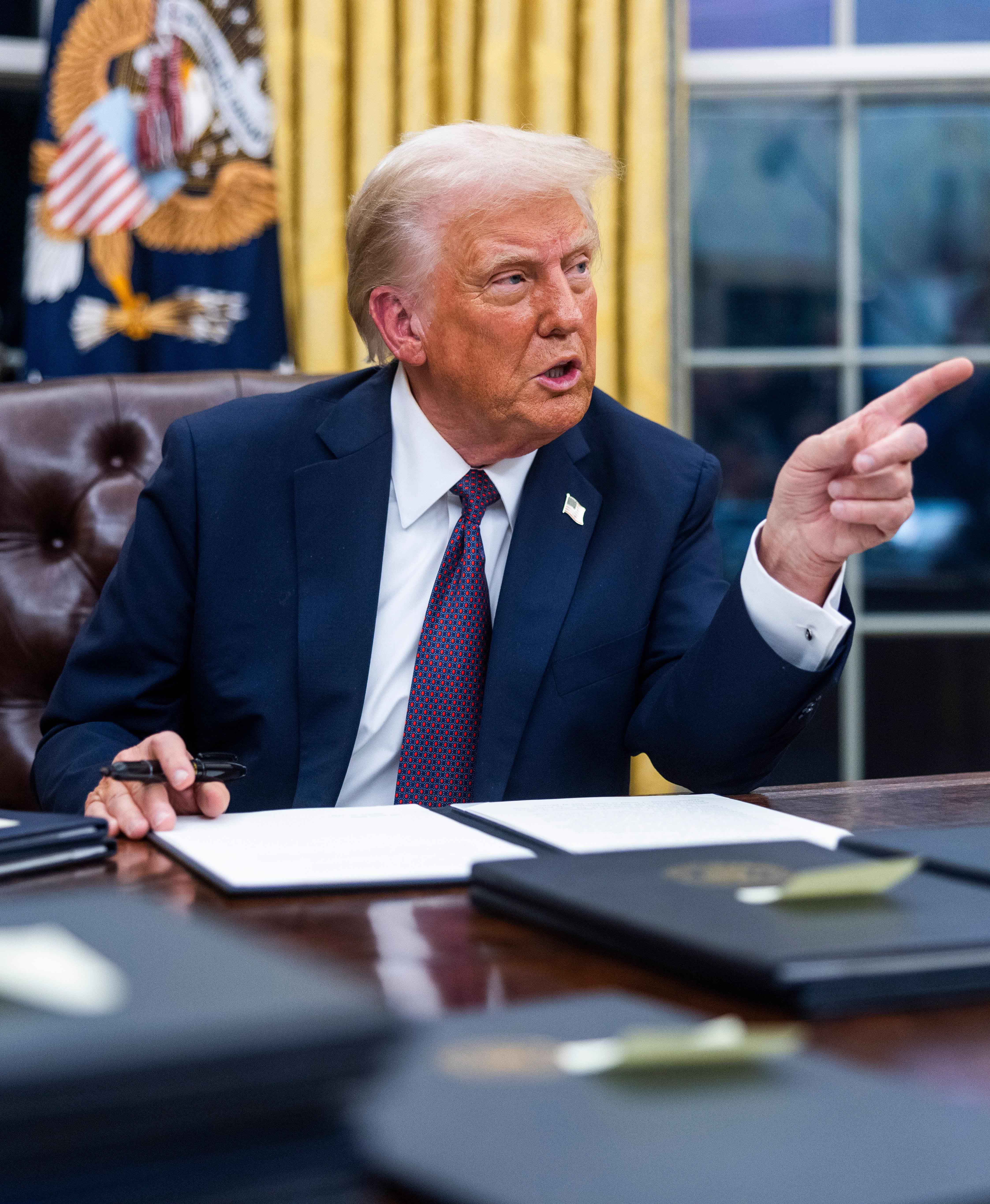 US President Donald Trump signing executive orders in the Oval Office