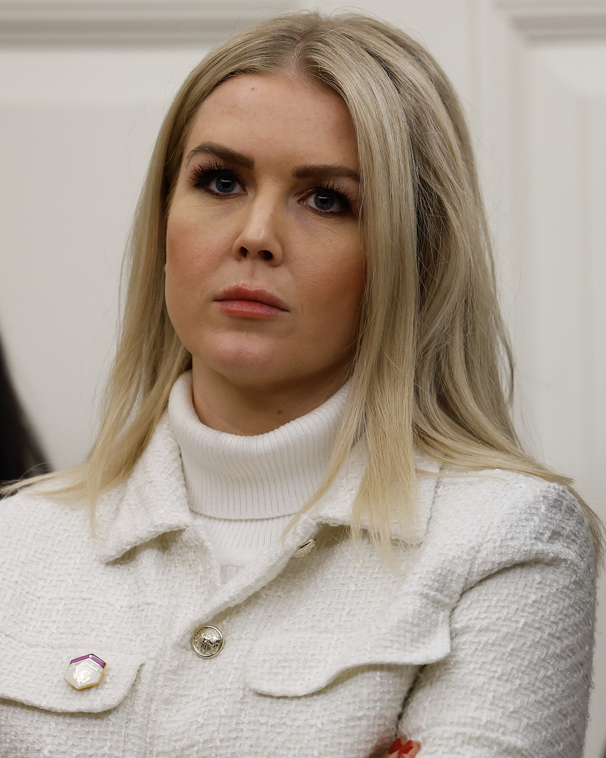 White House press secretary Karoline Leavitt looks on as US President Donald Trump signs executive orders