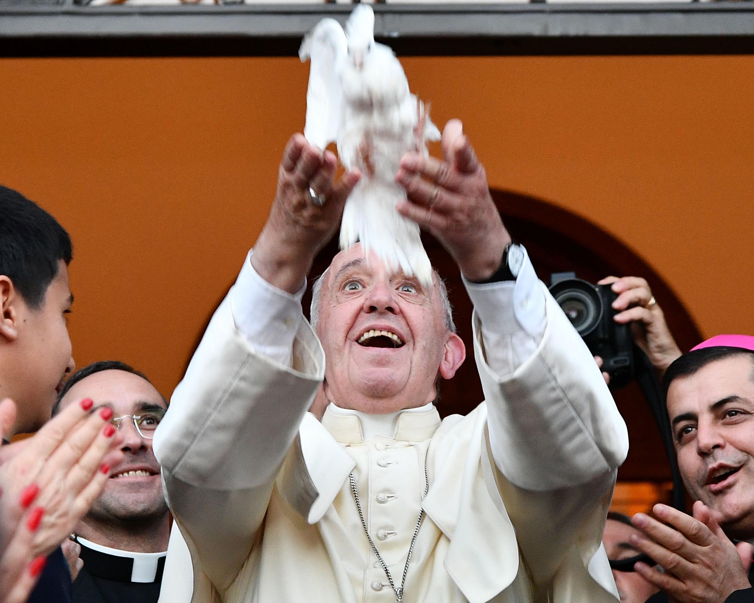 Pope Francis releases a dove during a meeting with Chaldean community at the Catholic Church of St Simon Bar Sabbae in Tbilisi, in 2016