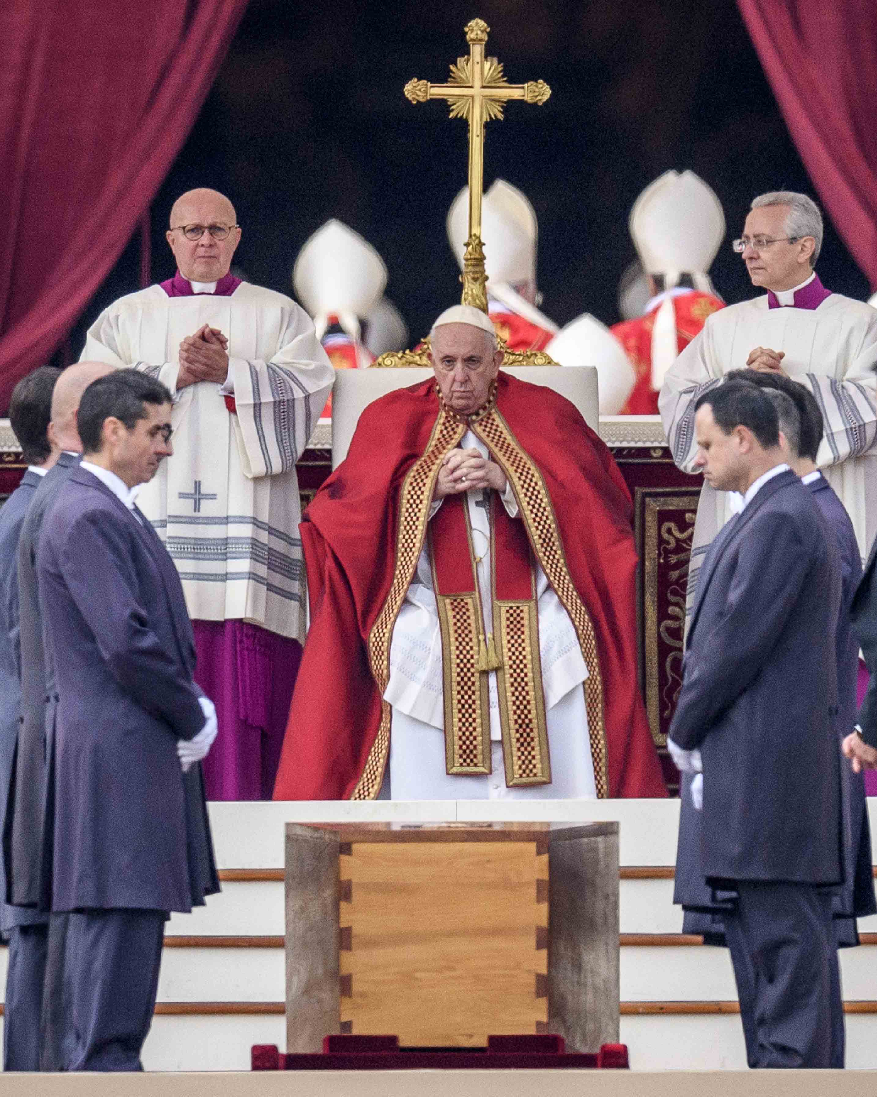 Pope Francis sits behind Pope Benedict's coffin in St Peter's Square
