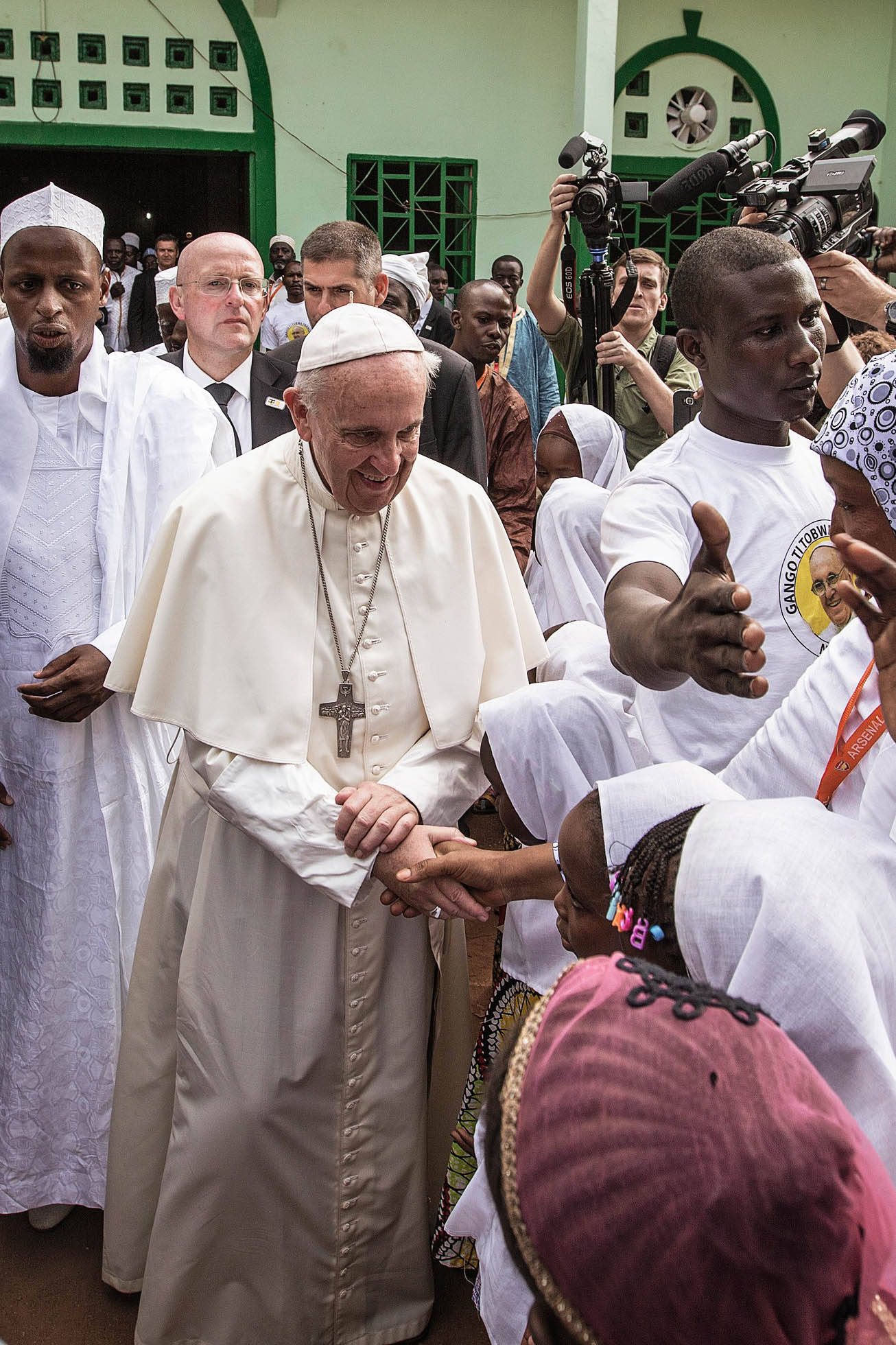 Pope Francis shakes the hands of children outside the Central Mosque, in Bangui, Central African Republic