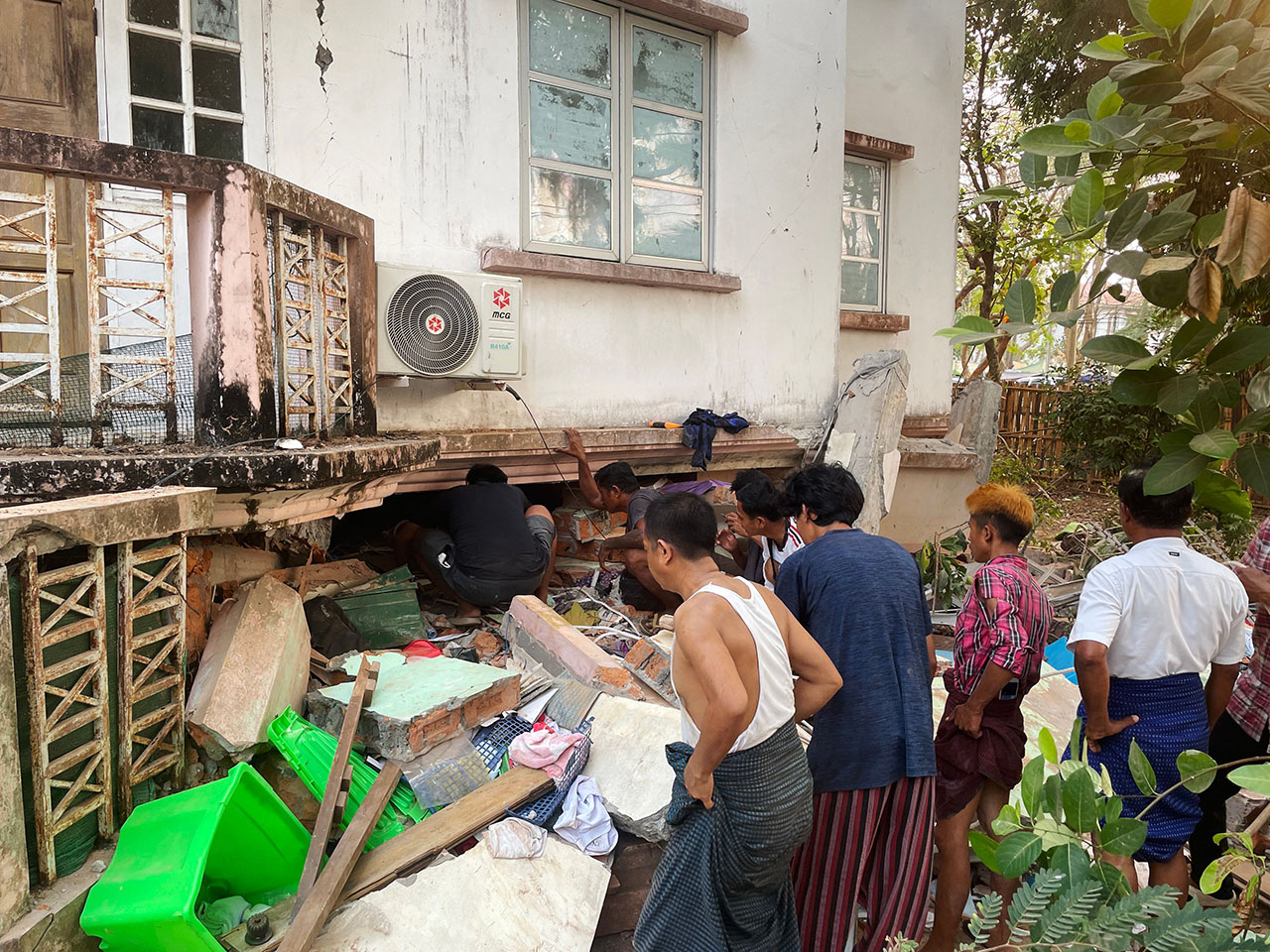 People search for survivors in damaged government staff housing buildings following an earthquake in Nay Pyi Daw, Myanmar