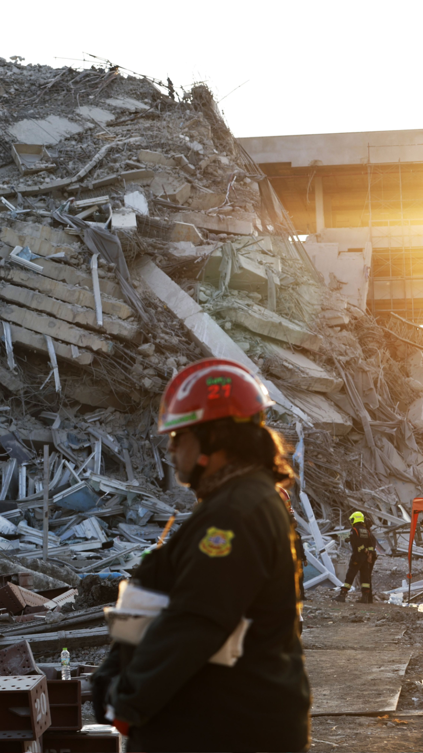Rescue workers search for survivors of a building collapse after an earthquake in Bangkok.
