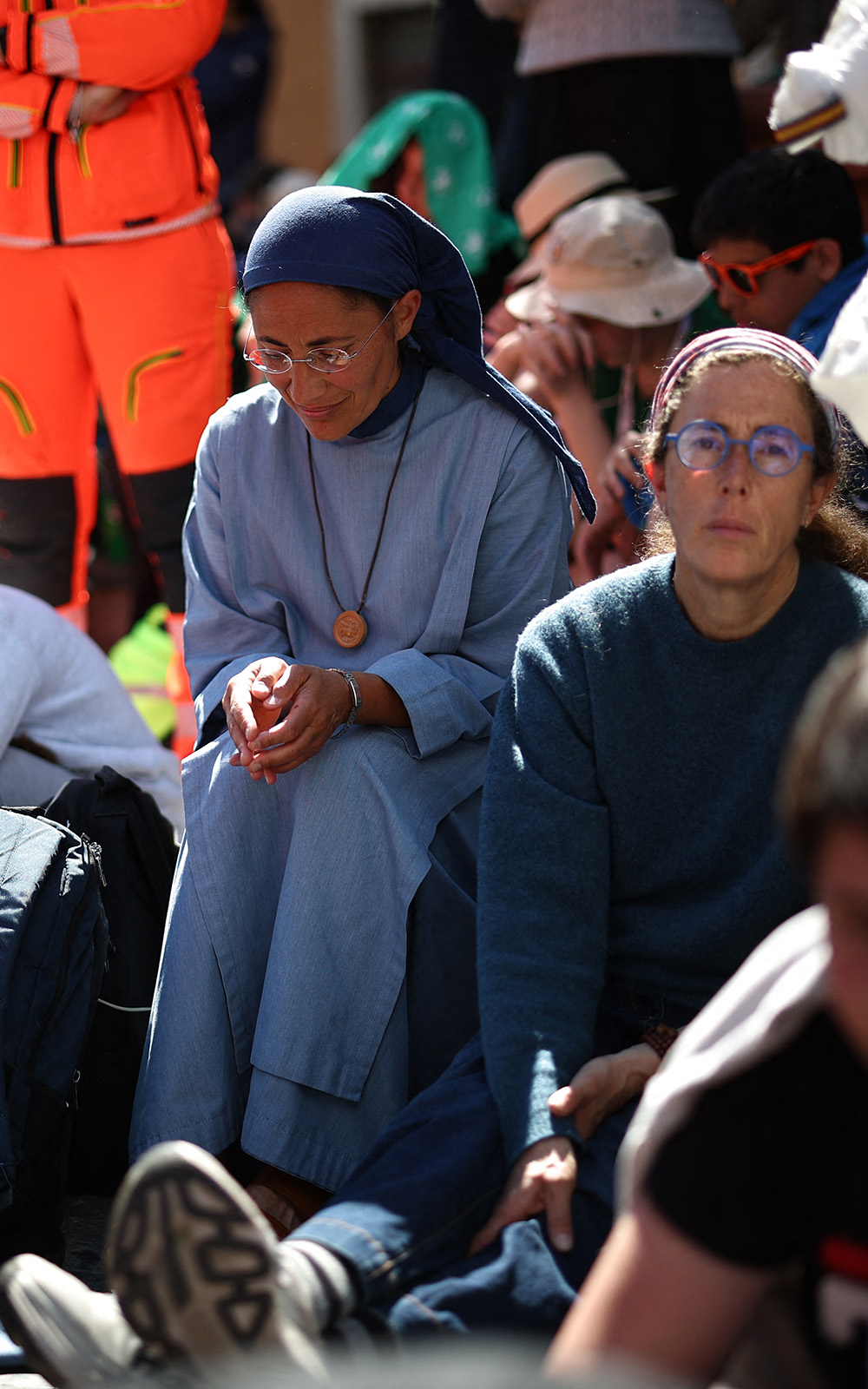 A nun (C) sits along Via della Conciliazione street during Pope Francis' funeral ceremony