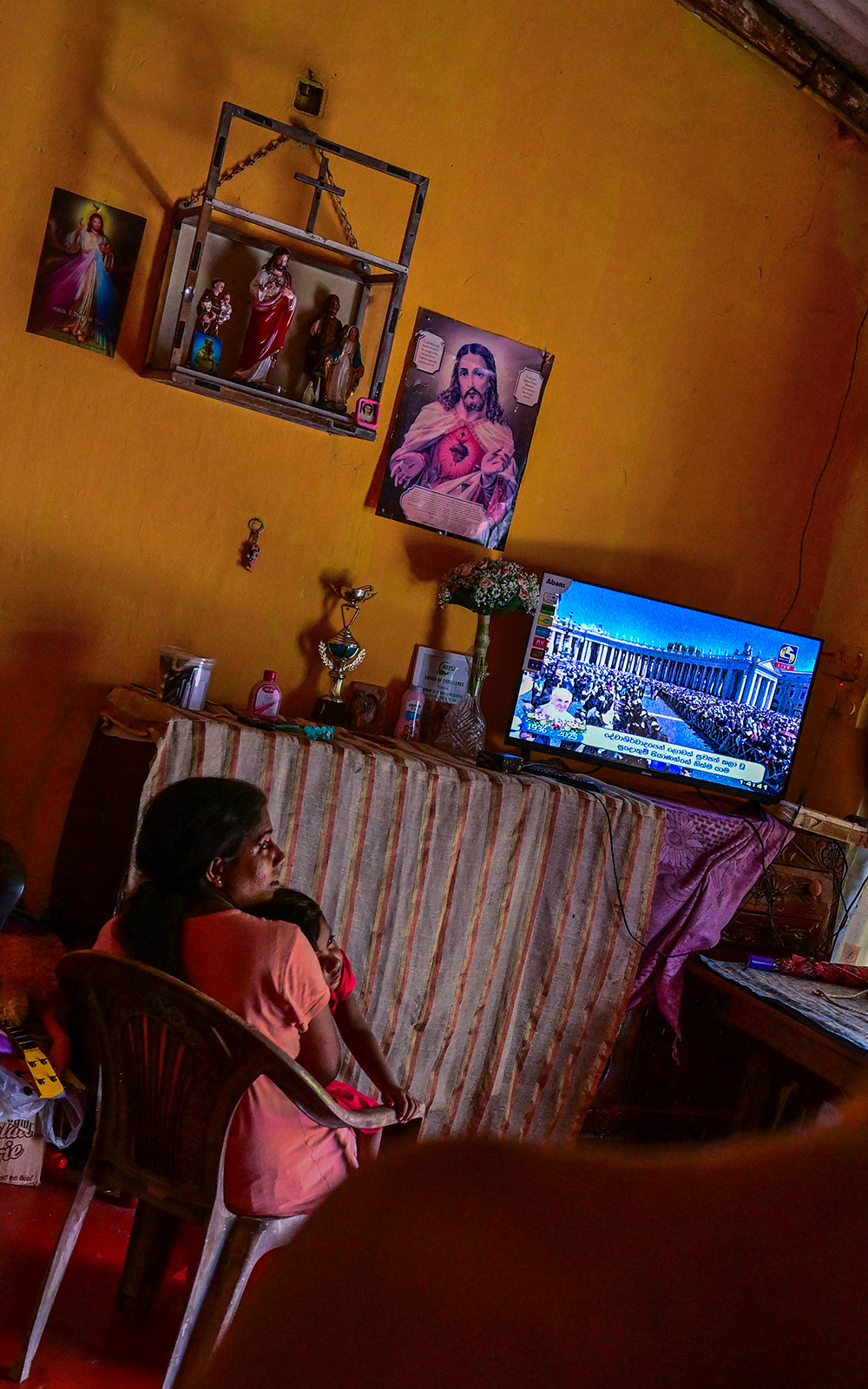A Catholic watches a live telecast of the funeral for the late Pope Francis taking place at St Peter's Square in the Vatican, in Colombo