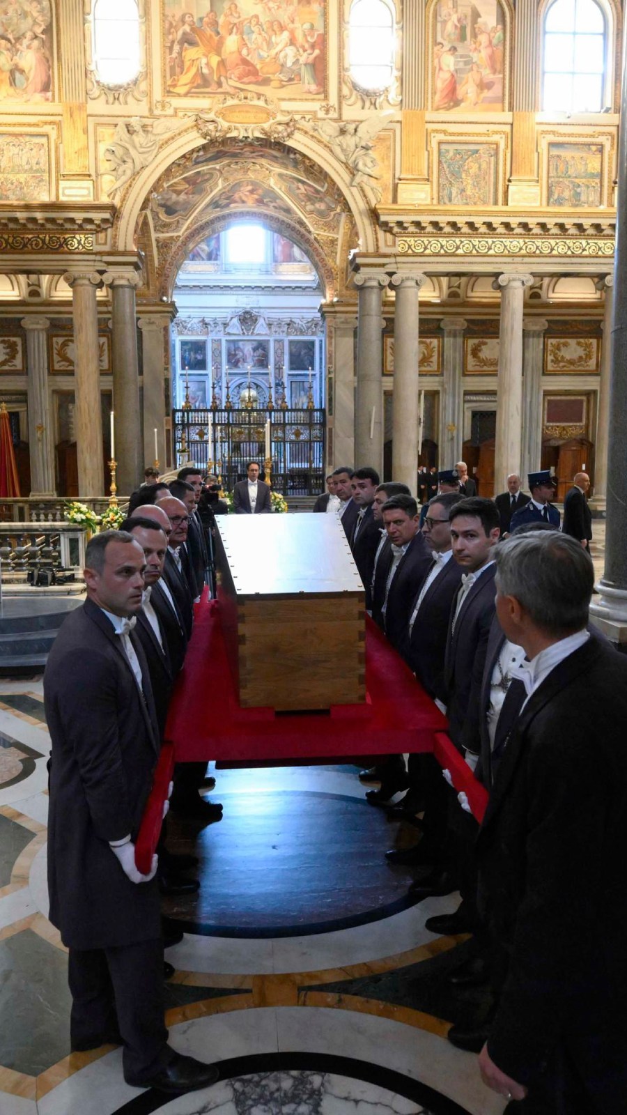 A handout picture provided by the Vatican Media shows pallbearers carrying the coffin of late Pope Francis during his burial at the Basilica of Santa Maria Maggiore in Rome