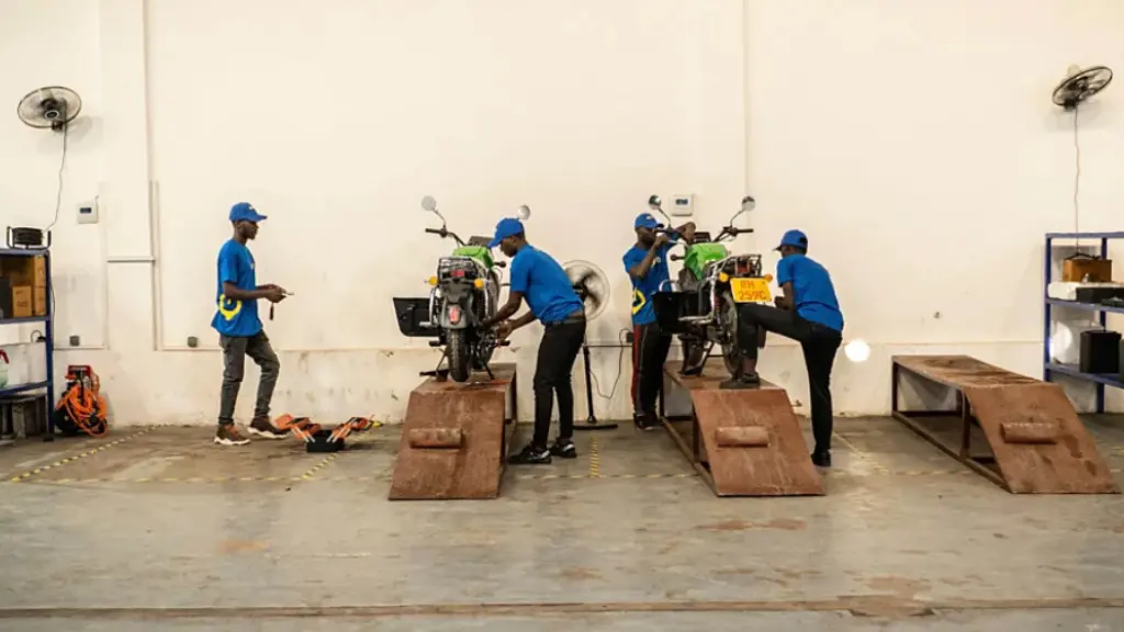 Workers at the startup Spiro service the company's e-bikes