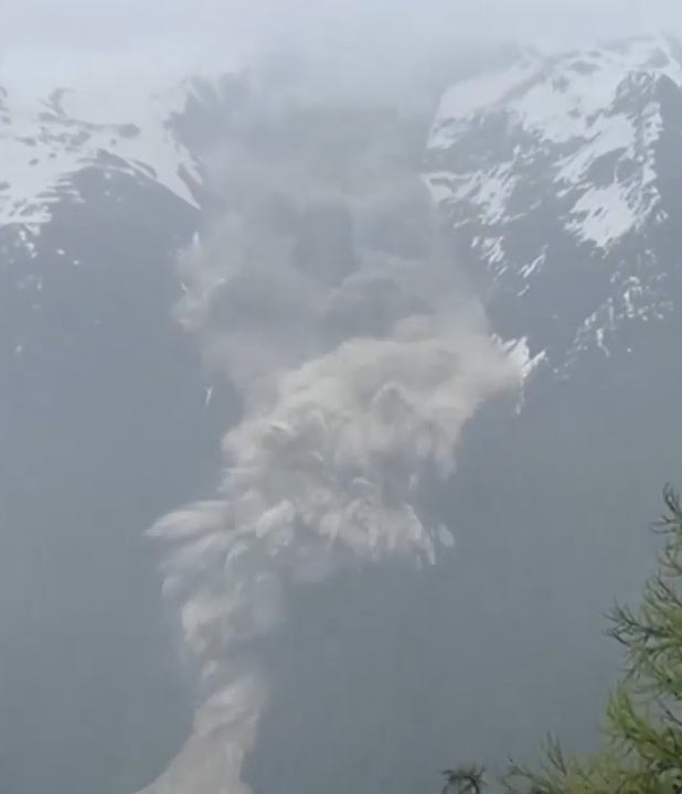Still image from video of the landslide in Blatten showing ice and rocks falling on the village
