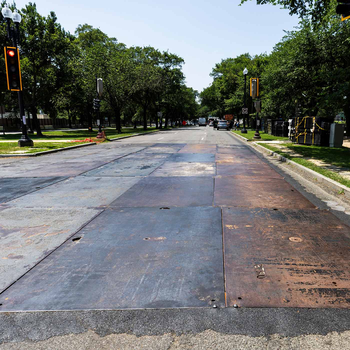 Newly installed steel plates cover Independence Avenue to help protect the street from tanks