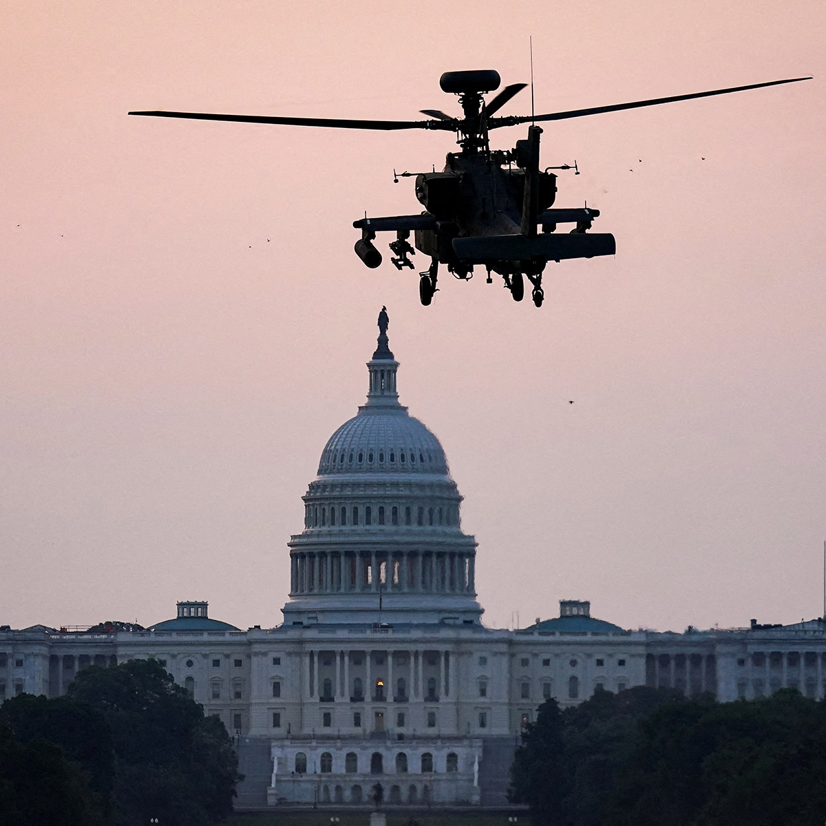 An Apache attack helicopter prepares to land on the National Mall near the US Capitol in Washington DC