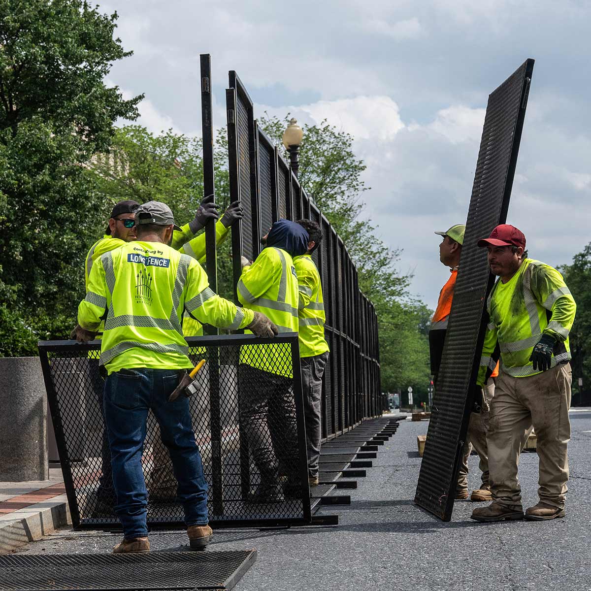 Workers install a security fence on the National Mall in Washington DC