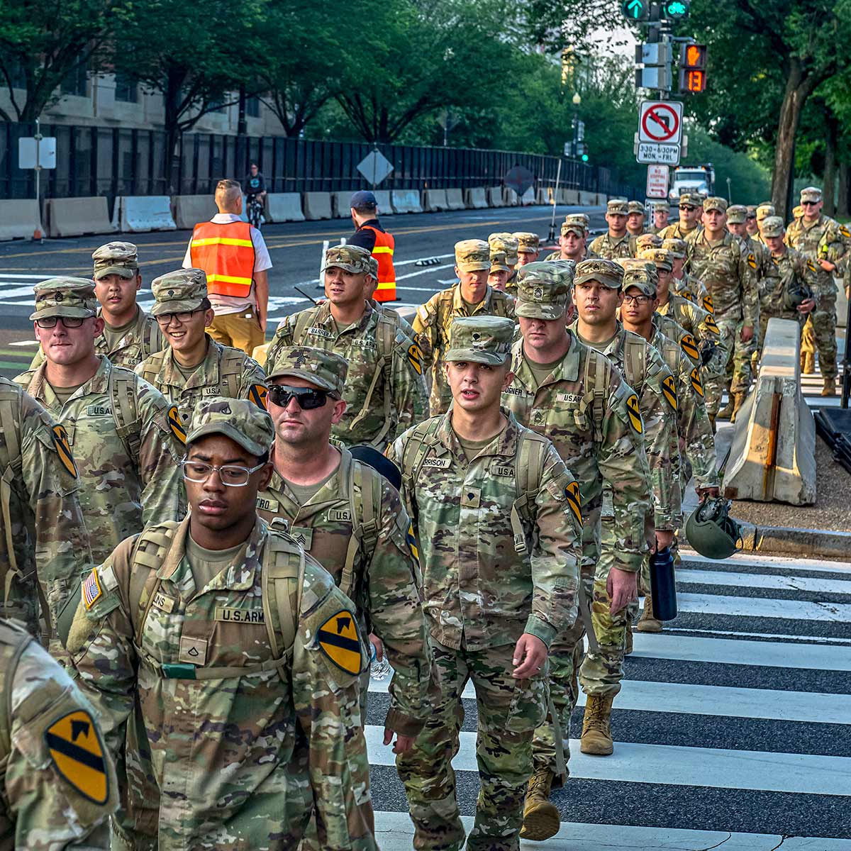 Members of the US Army's First Cavalry Division march along the National Mall at dawn