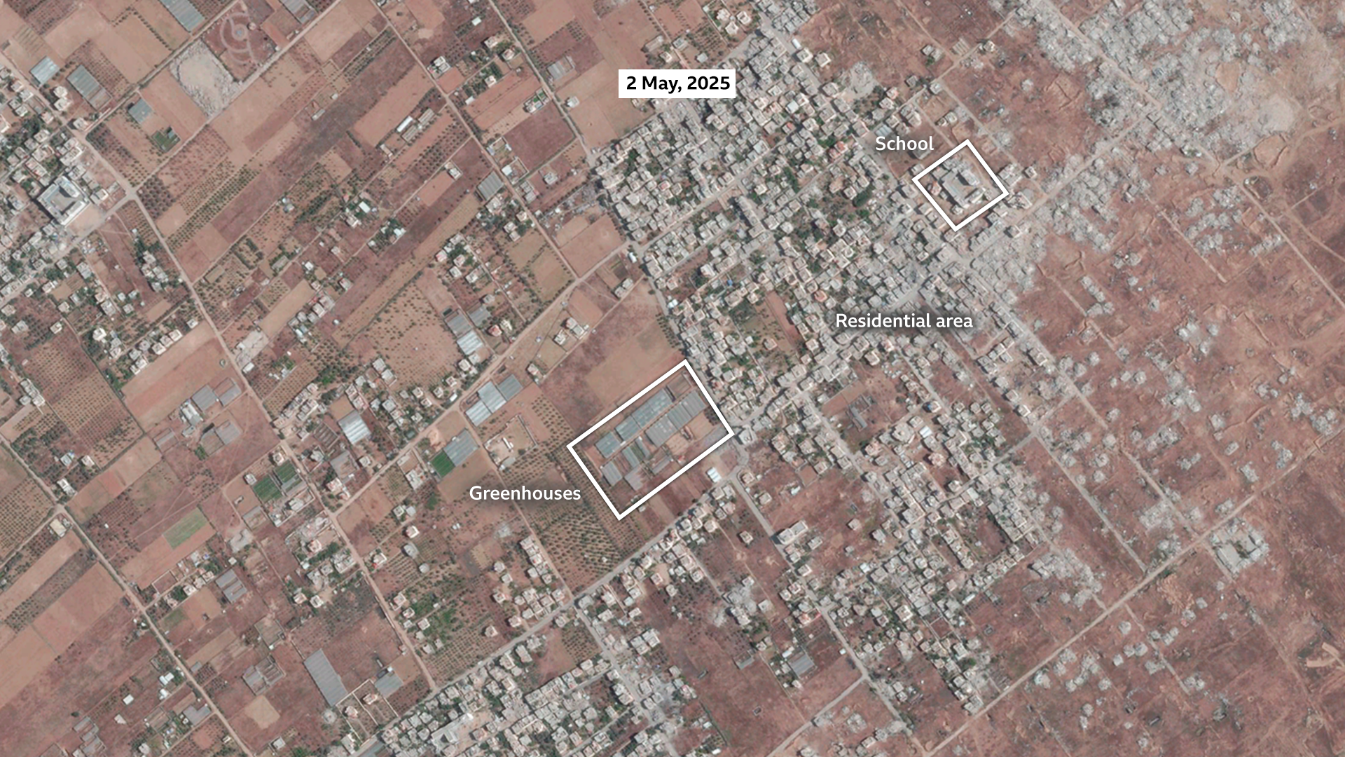 A satellite image of Khuza'a on 2 May, 2025. The area with the majority of the buildings is labelled as the main settlement. A smaller area is labelled as greenhouses