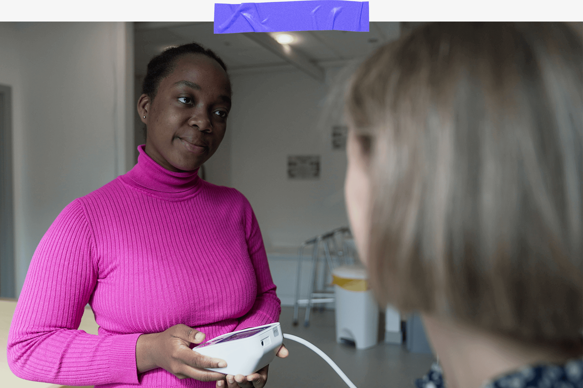 Halima taking someone's blood pressure