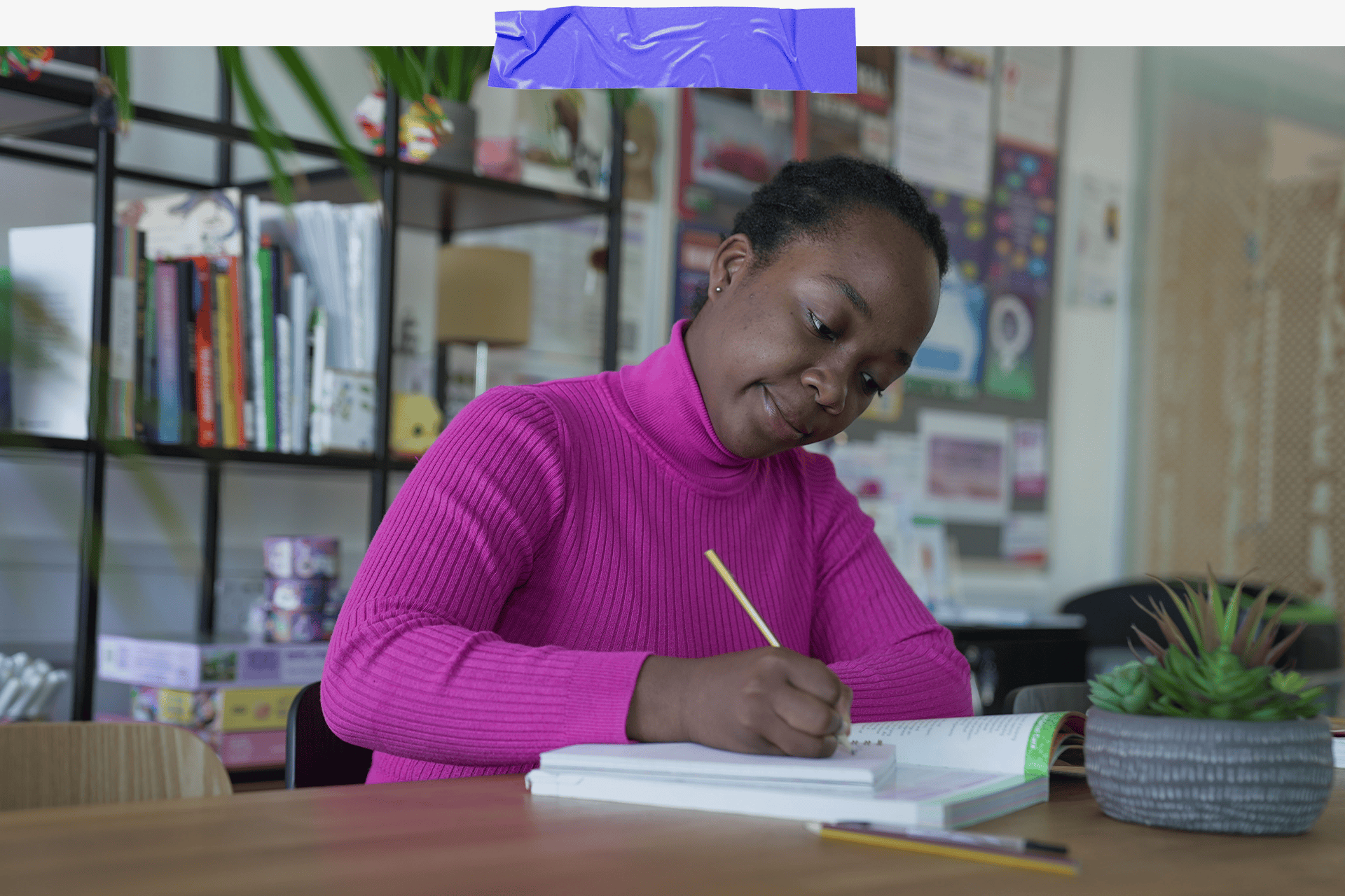 Halima studying at her desk 