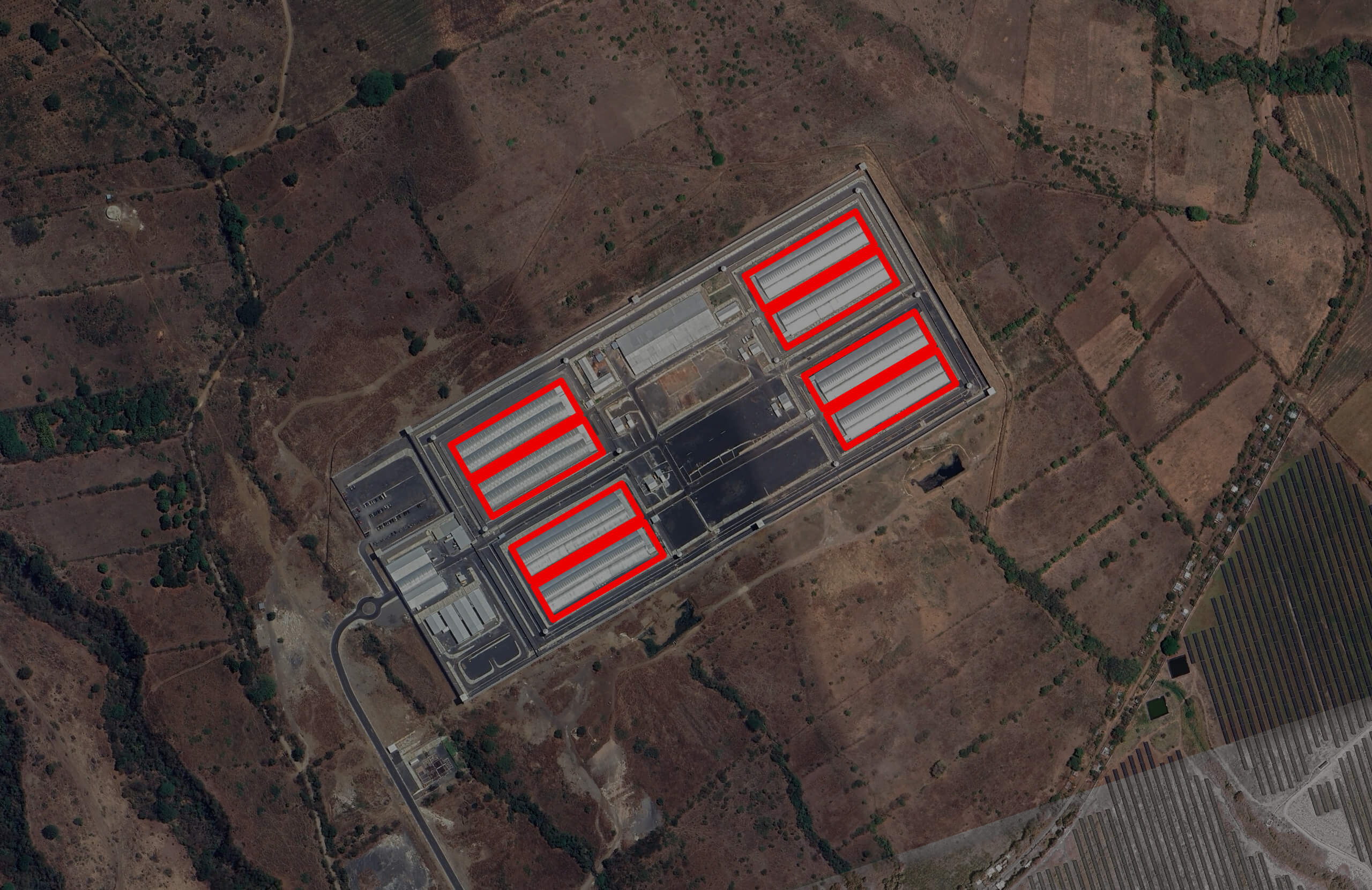 Aerial image of the Cecot prison with cell blocks highlighted inside red lines