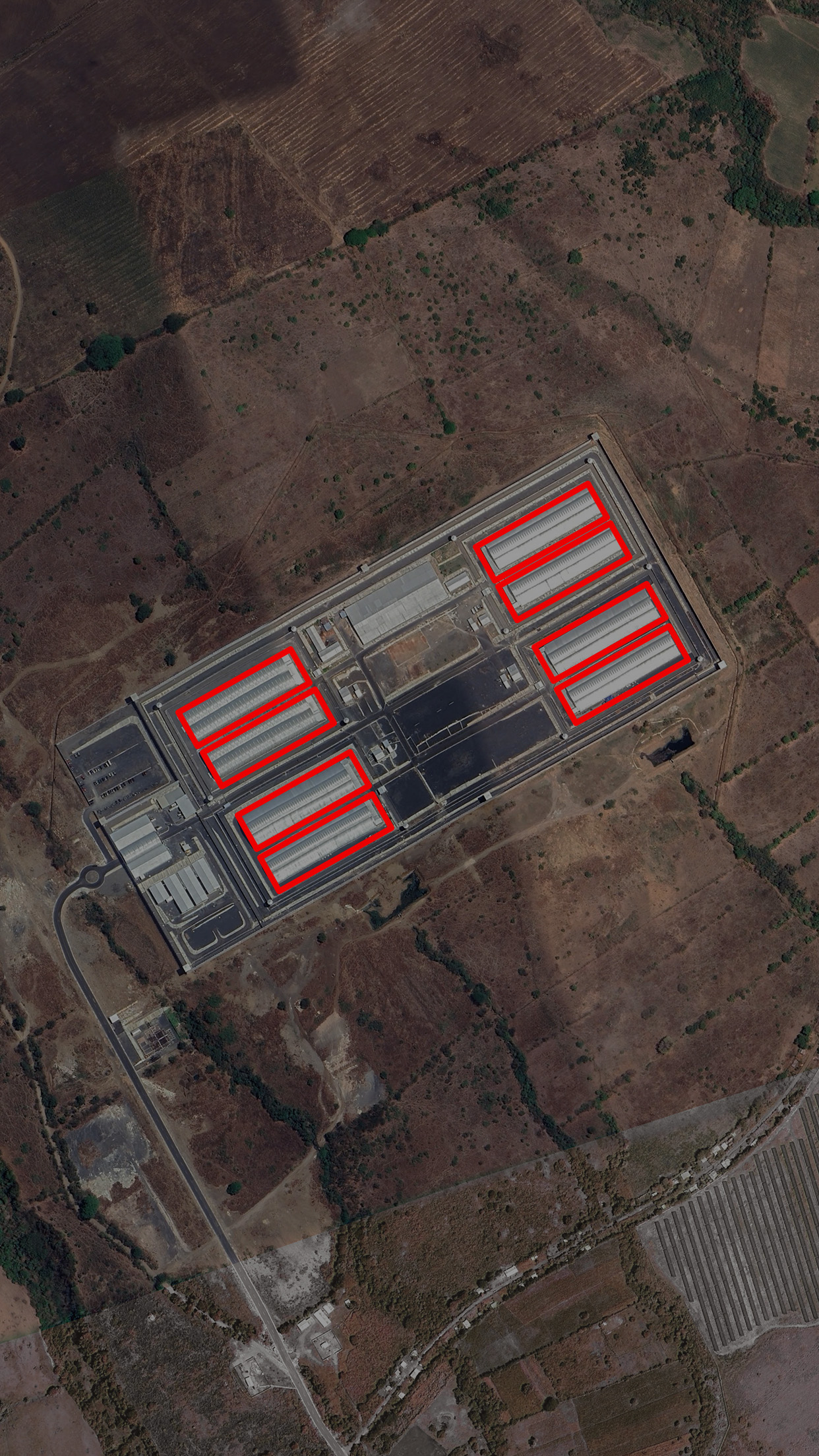 Aerial image of the Cecot prison with cell blocks highlighted inside red lines