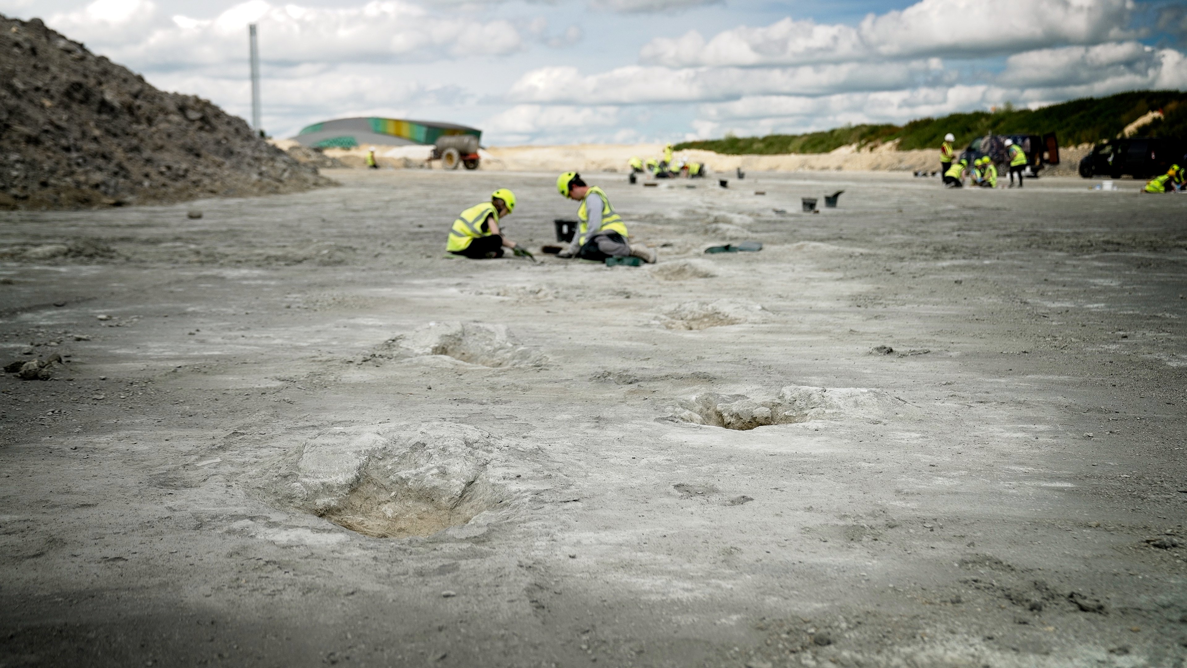 A view of the trackway from near the ground. A series of hollows with bumps of stone heads into the distance away from the camera.