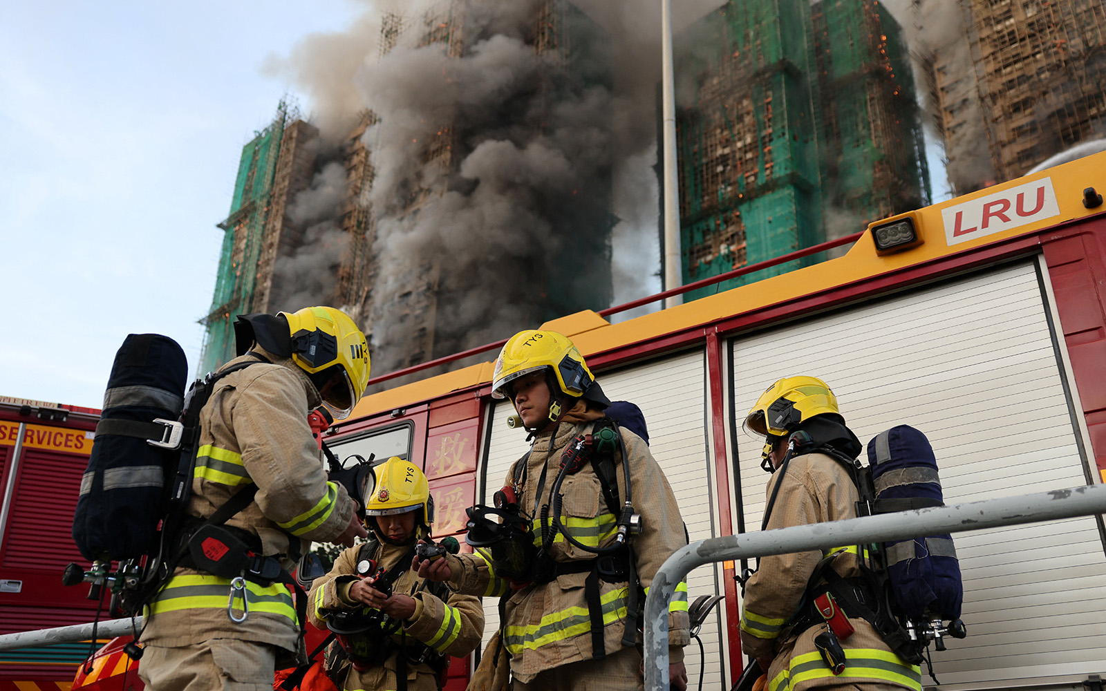 Firefighters work as efforts are underway to extinguish flames engulfing bamboo scaffolding across multiple buildings at the Wang Fuk Court housing estate in Tai Po, Hong Kong, China, November 26