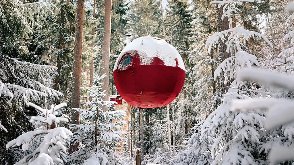 Exterior of a modern tree house in a forest overlooking a lake and mountains (Credit: Woodnest/ Sindre Ellingsen)