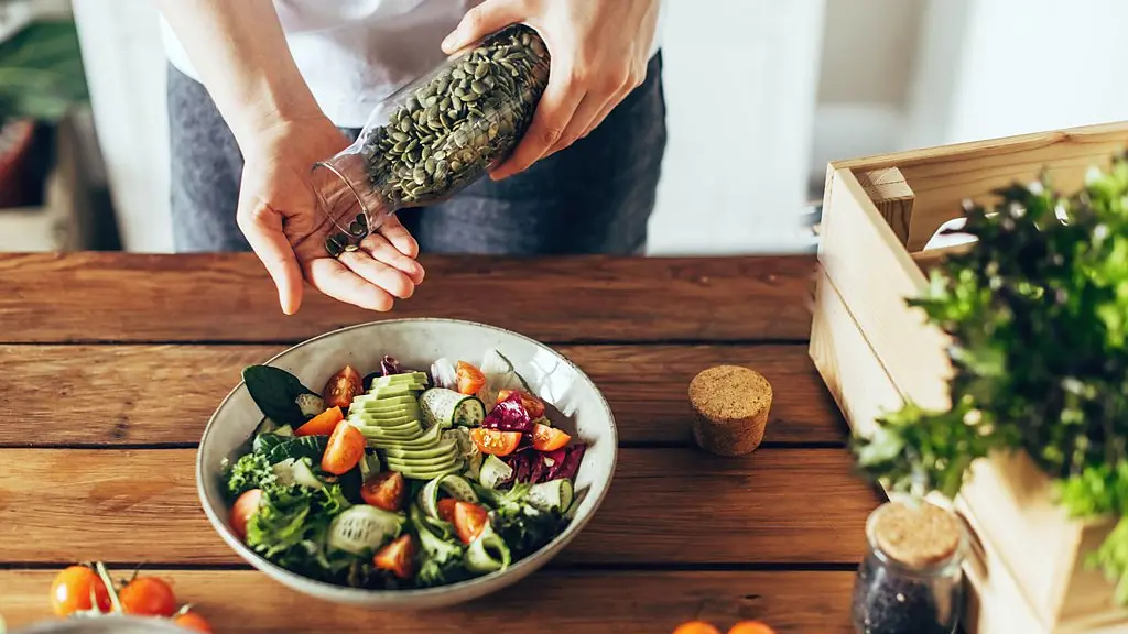 Hand holding a handful of almonds (Credit: Getty Images)