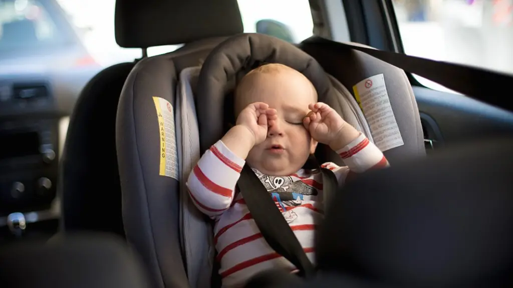 A cheeky infant is standing in a crib (Credit: Getty Images)