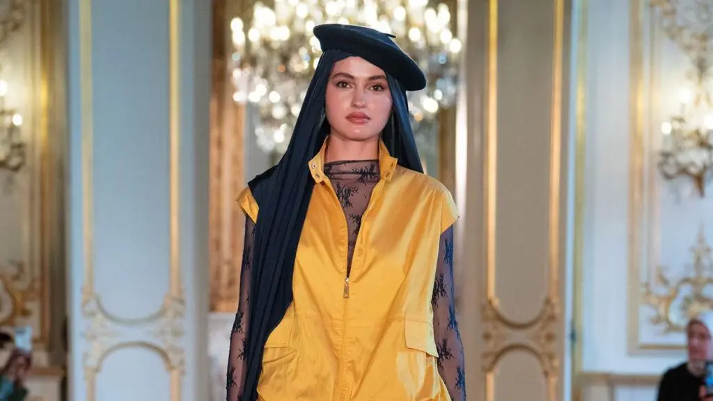 A model walks the runway wearing a headscarf and beret during the Paris Modest Fashion Weeks 2026 by Think Fashion at Hotel Le Marois on April 16, 2026 in Paris, France