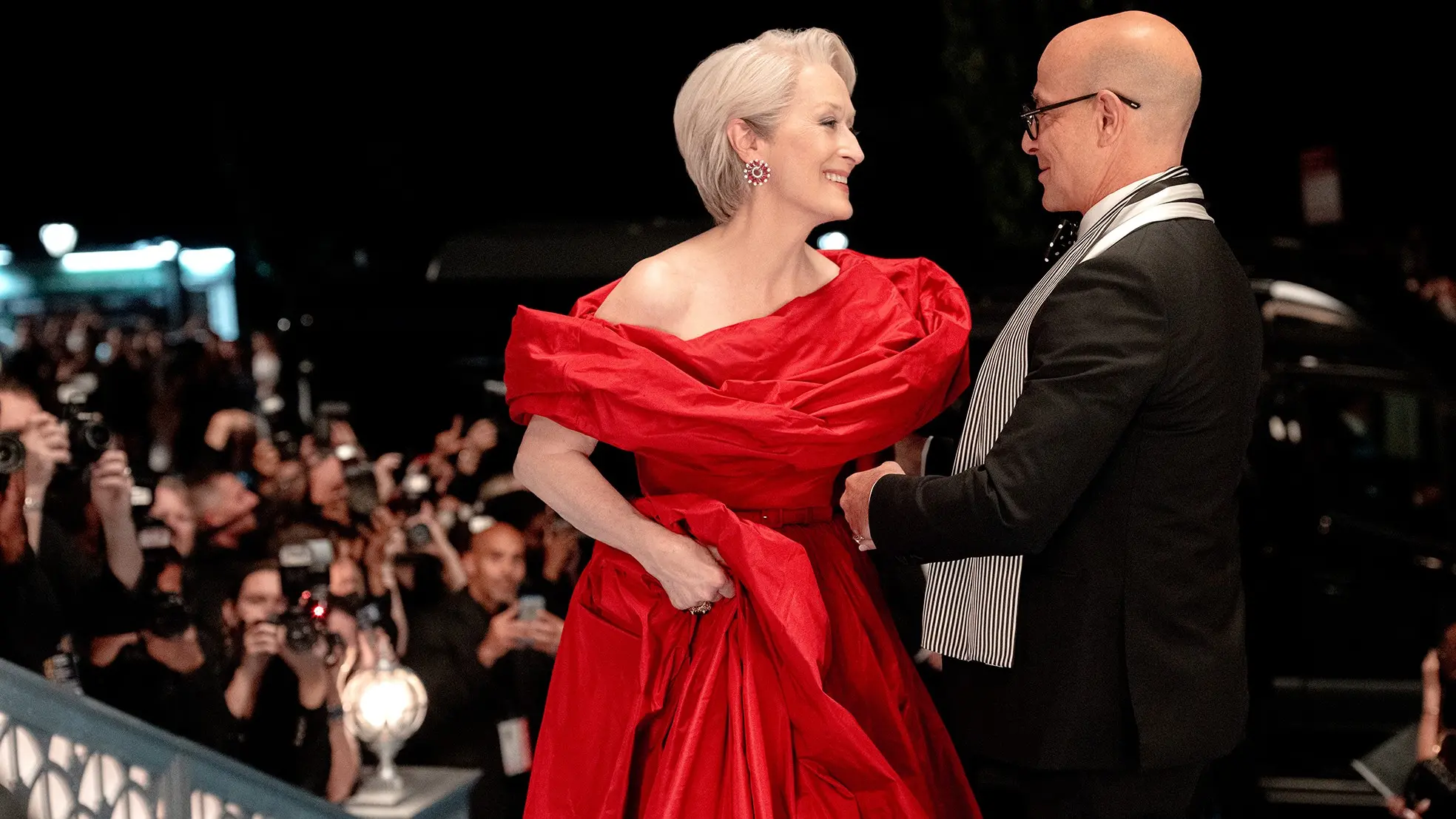 Meryl Streep in a red gown next to Stanley Tucci in The Devil Wears Prada 2 (Credit: 20th Century Fox)