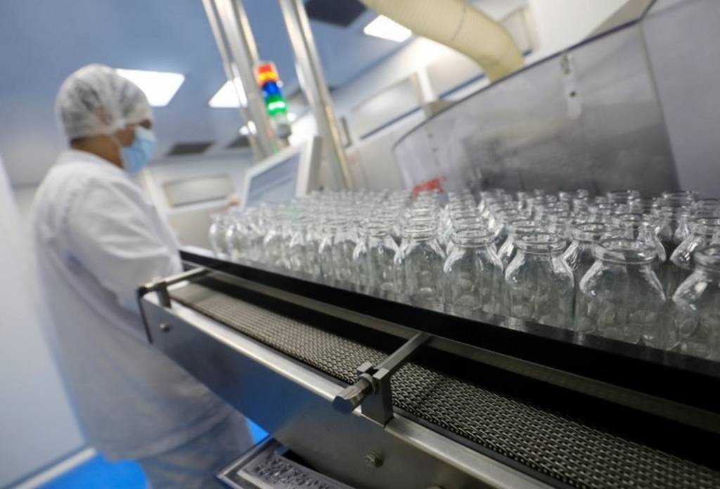 A lab technician works on investigational coronavirus disease (COVID-19) treatment drug 