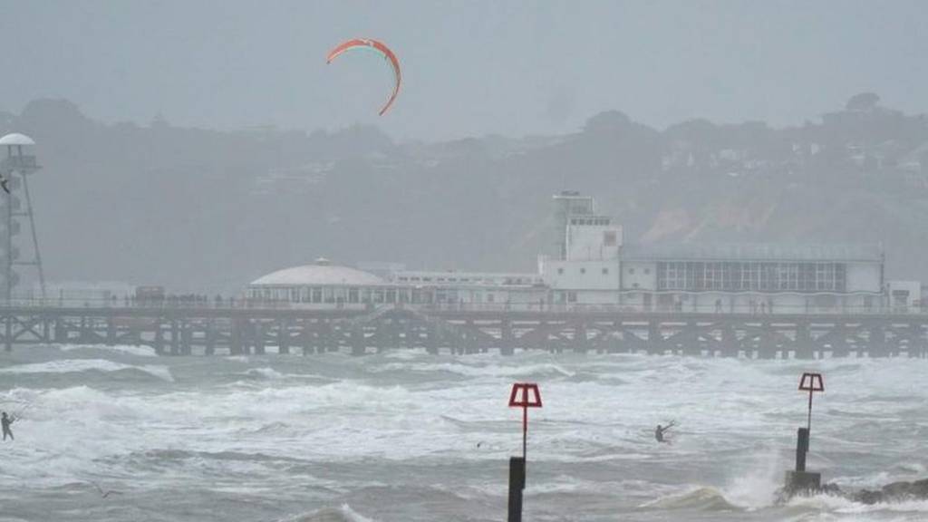 People kite surfing off Boscombe Beach, Dorset