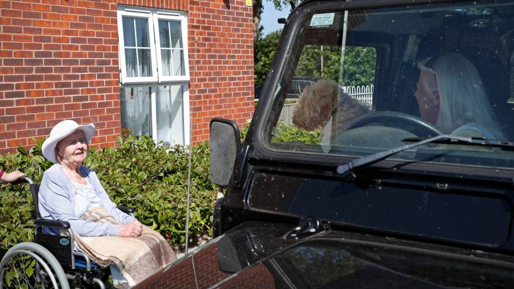 Two women converse outside a care home in Oxfordshire (file pic)