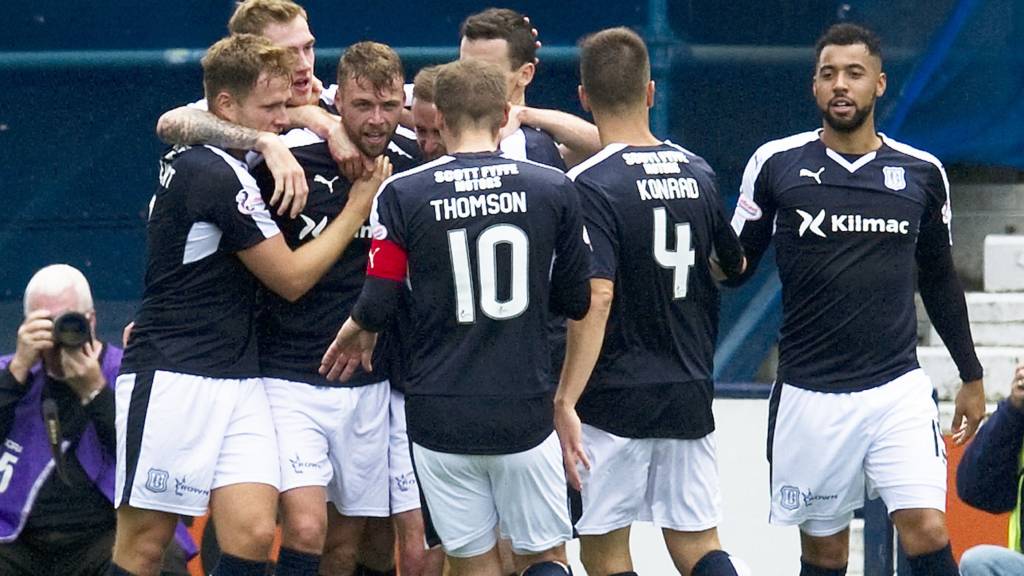 Dundee players celebrate one of their three goals at Rugby Park