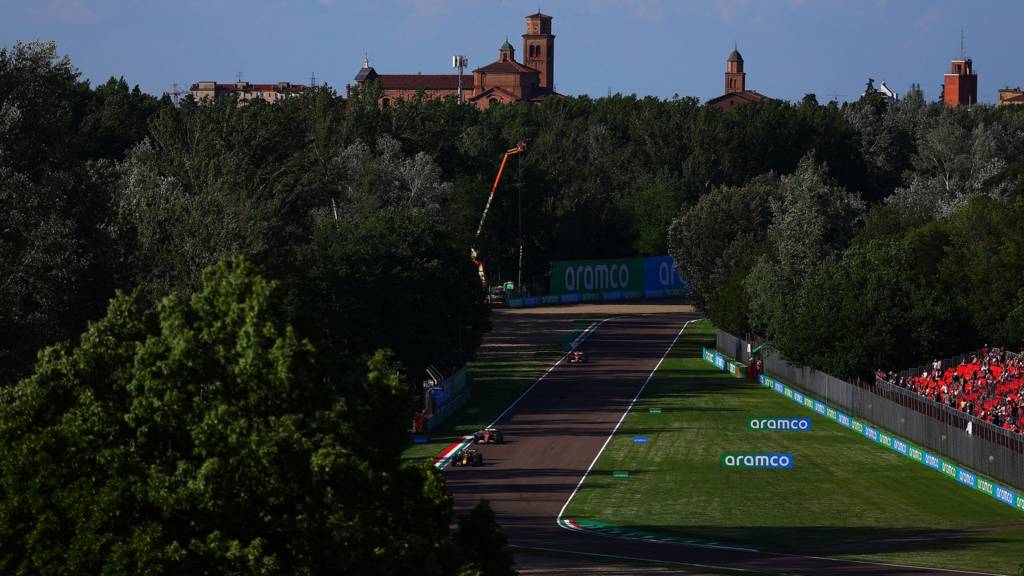 View of Imola circuit with a church and the roofs of houses in the background