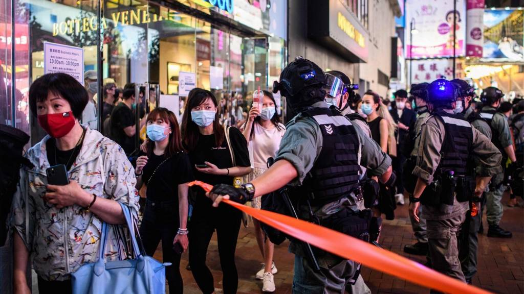 Police use a cordon as they conduct a crowd clearing operation as pro-democracy protesters gathered in the Causeway Bay district of Hong Kong on June 12, 2020.