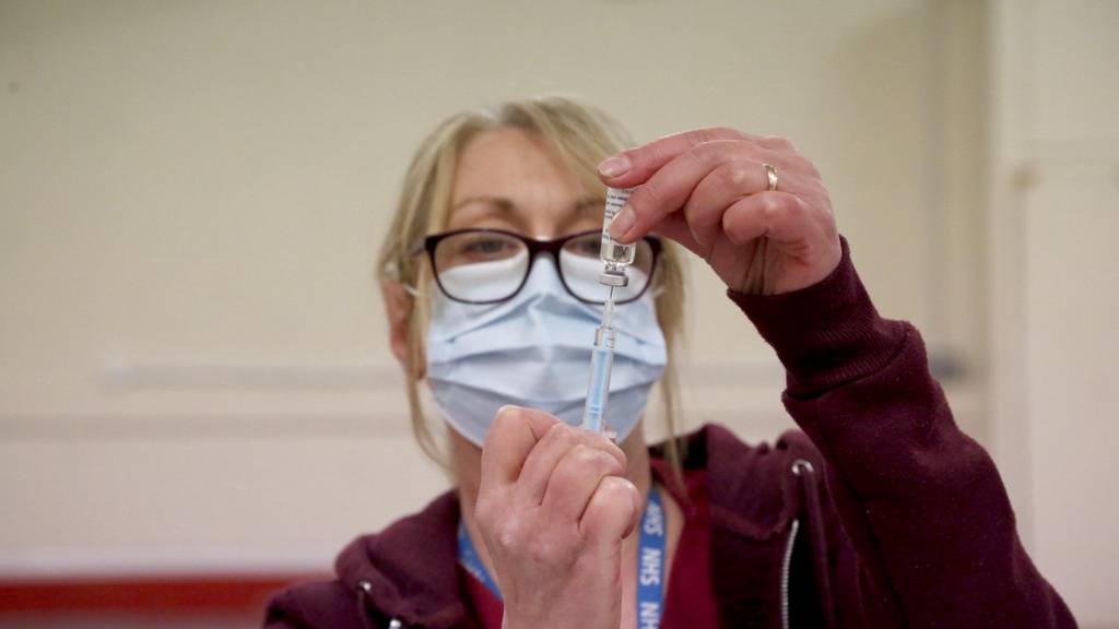 Vaccine dose being prepared