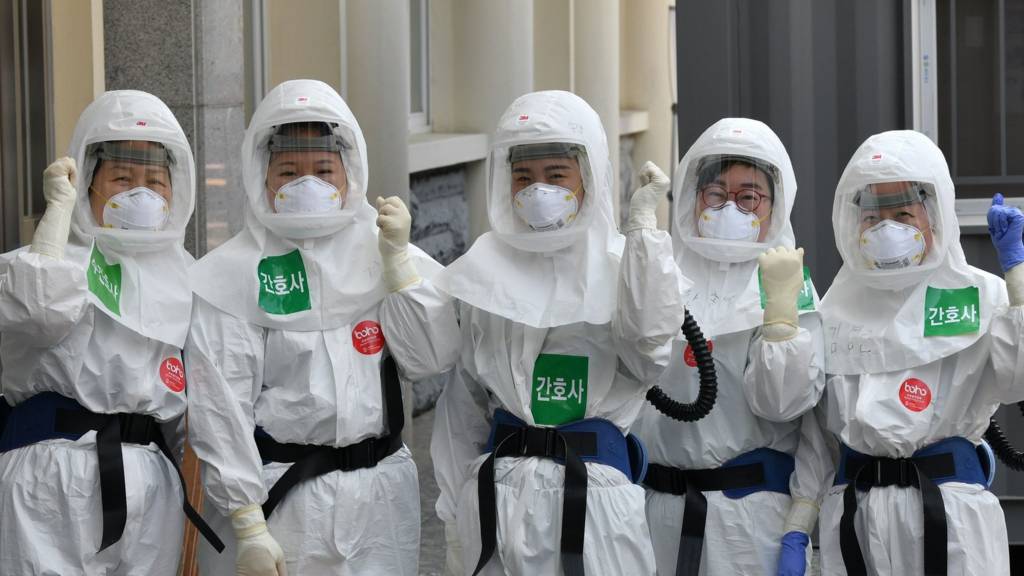 Nurses in protective gear pose before starting shift in Daegu, South Korea