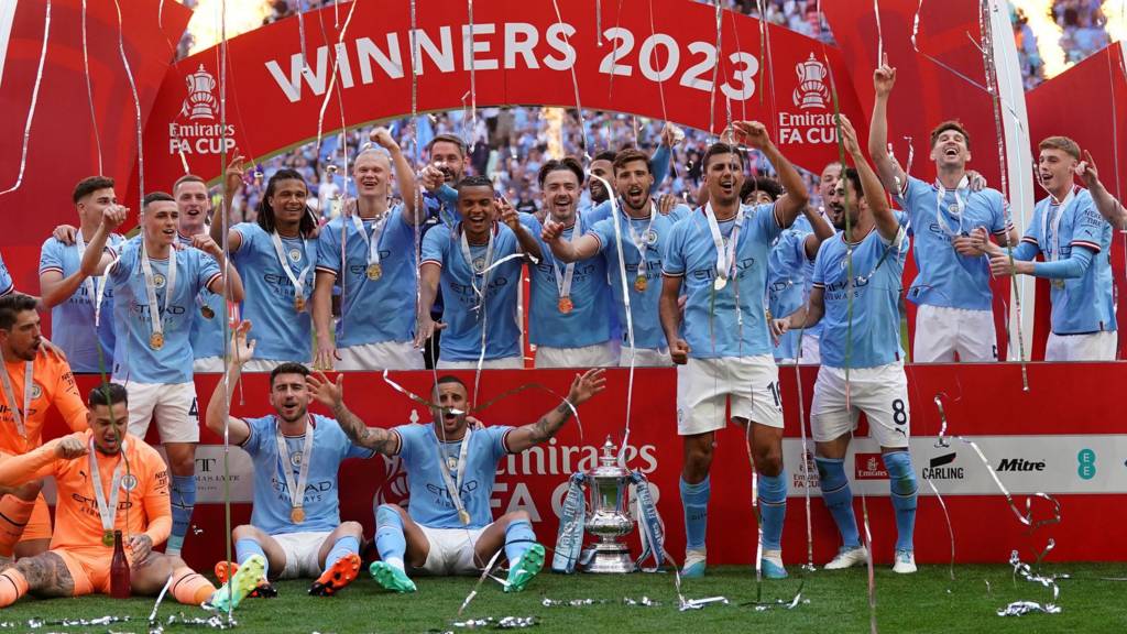 Manchester City's Erling Haaland holds the winners trophy as he celebrates  winning the English FA Cup final soccer match between Manchester City and  Manchester United at Wembley Stadium in London, Saturday, June