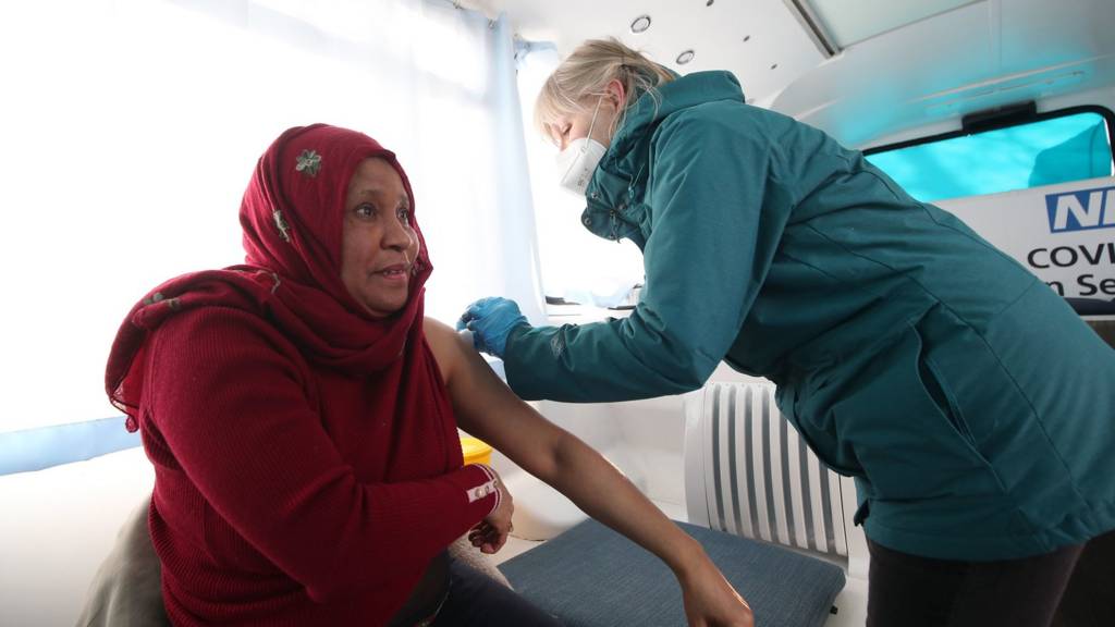 A woman is given a vaccine
