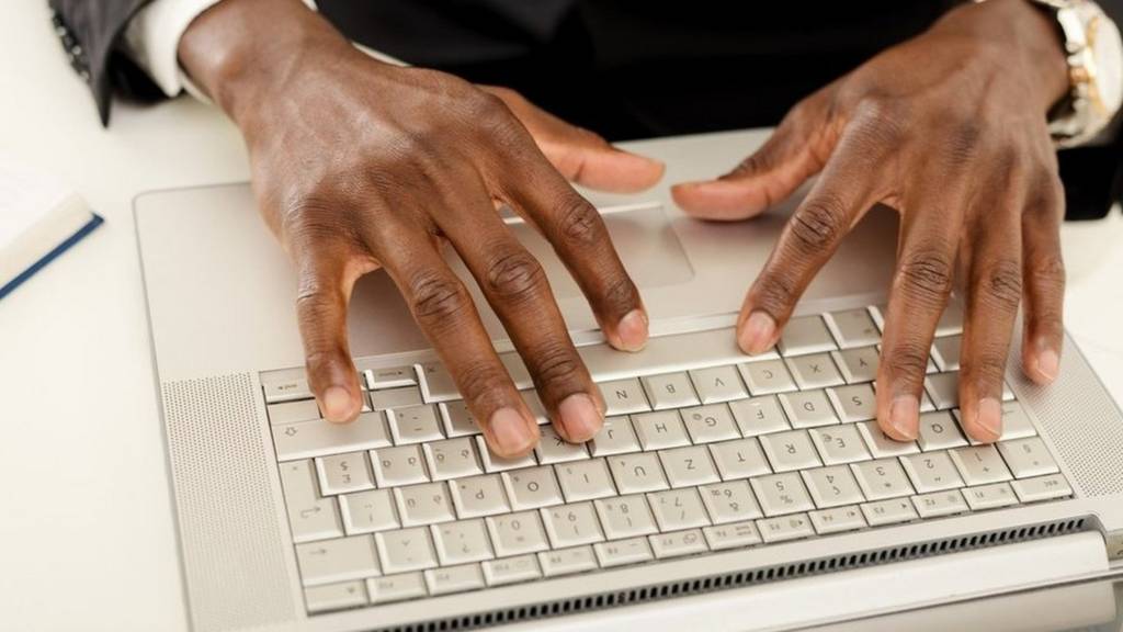 Hands on a computer keyboard