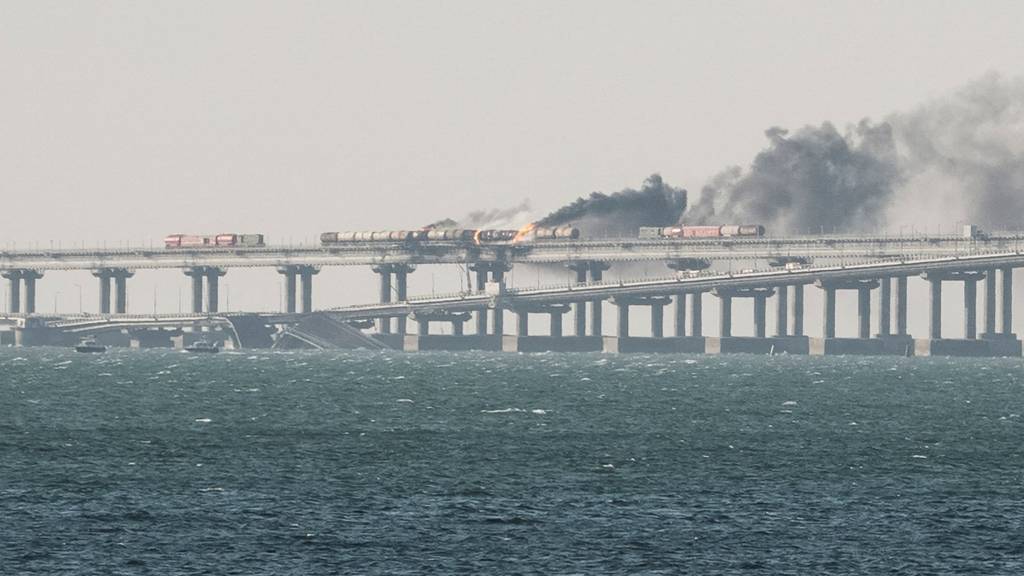 Fuel tanks ablaze and damaged sections of the Kerch bridge in the Kerch Strait, Crimea