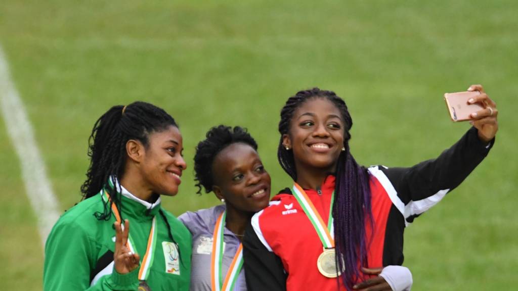 Medal-winning athletes pose for a selfie