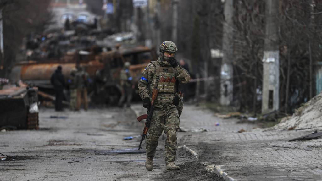 Ukrainian soldier patrols Bucha on 4 April 2022