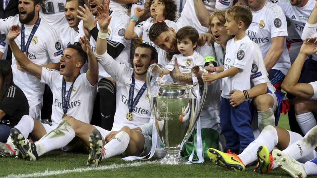 Real Madrid team pose with the trophy