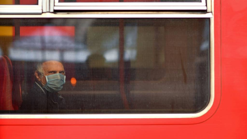 Man wearing face mask on a bus