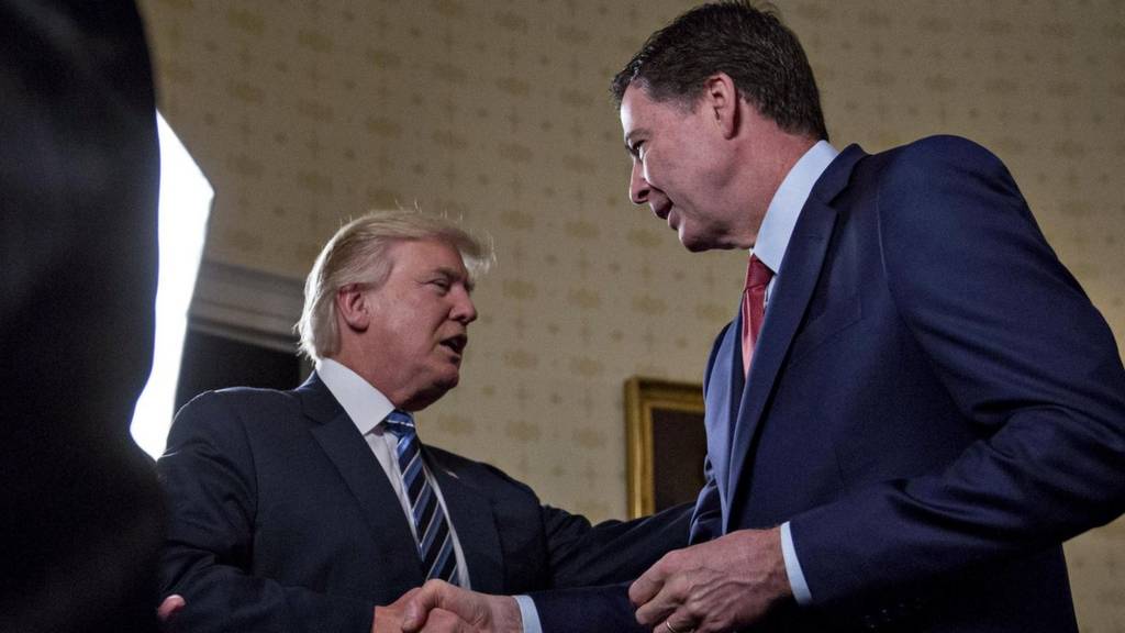 US President Donald Trump shakes hands with James Comey at the White House on January 22, 2017