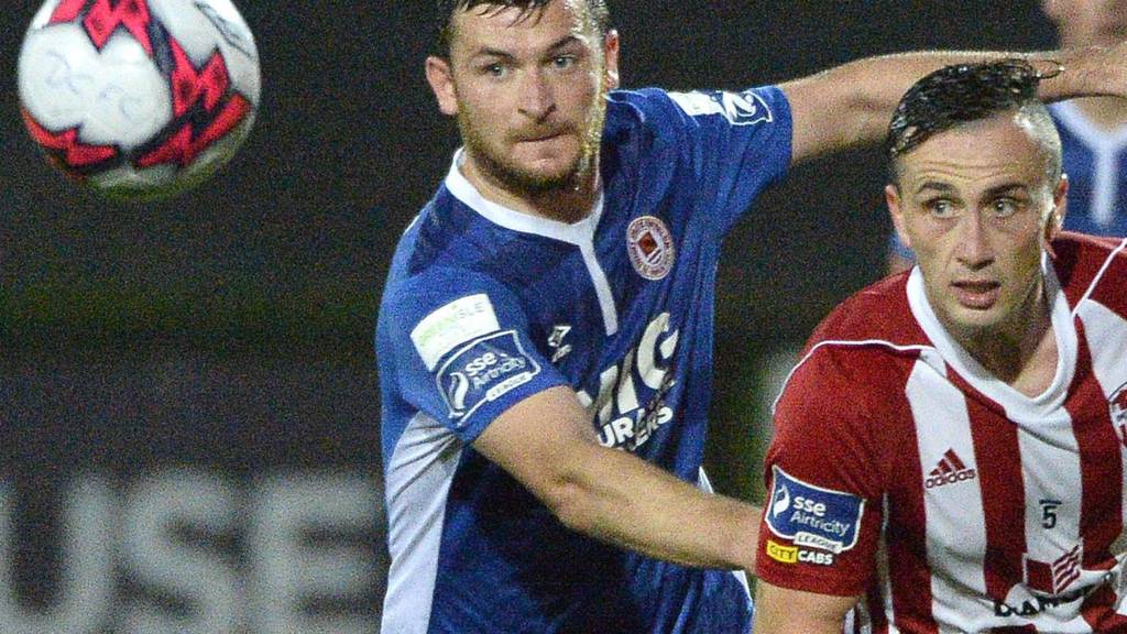 Kevin Toner of St Pat's challenges Derry midfielder Aaron McEneff
